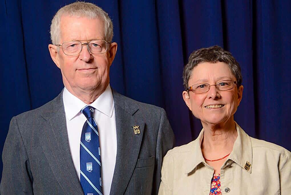 John and Pauline Applin portrait on blue background at the University of Maine