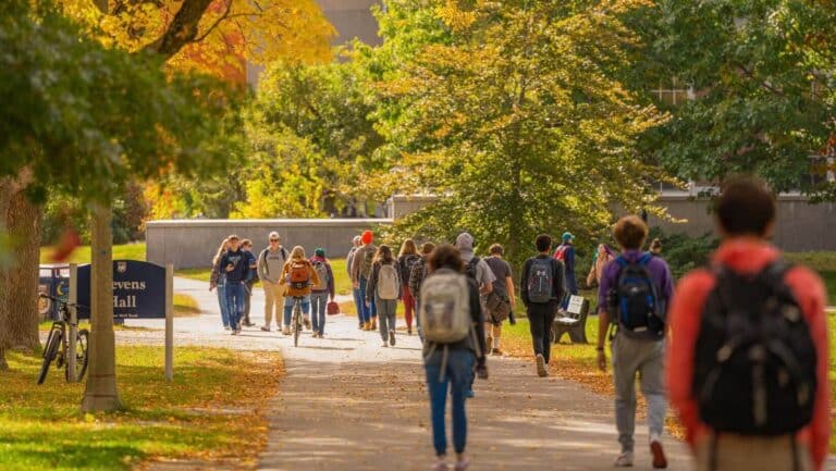 Students walk on campus in fall