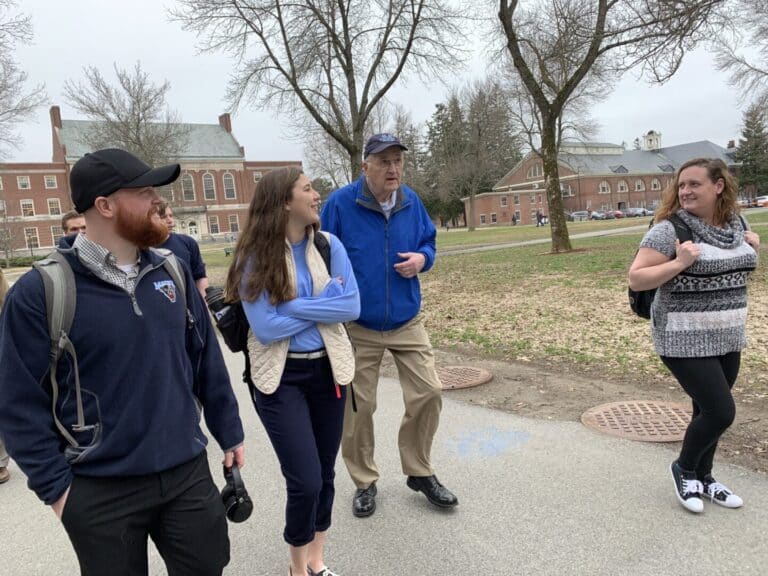 Norm Stetson walking on campus with students